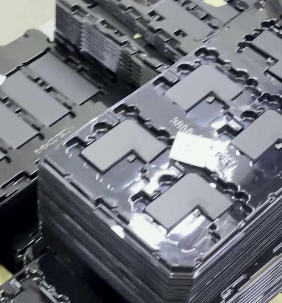 Replacement battery units arranged in trays on the factory floor